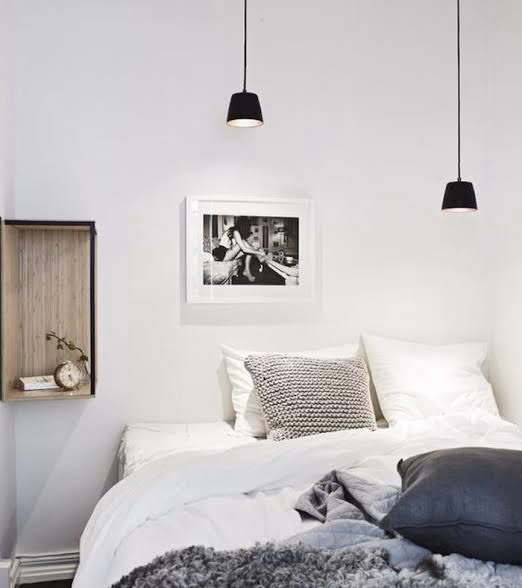 A successful room makeover with a black suspension above the bed