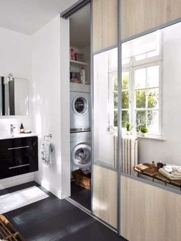 A laundry room behind a mirror door