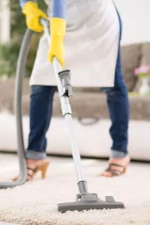 vacuum regularly to clean a carpet