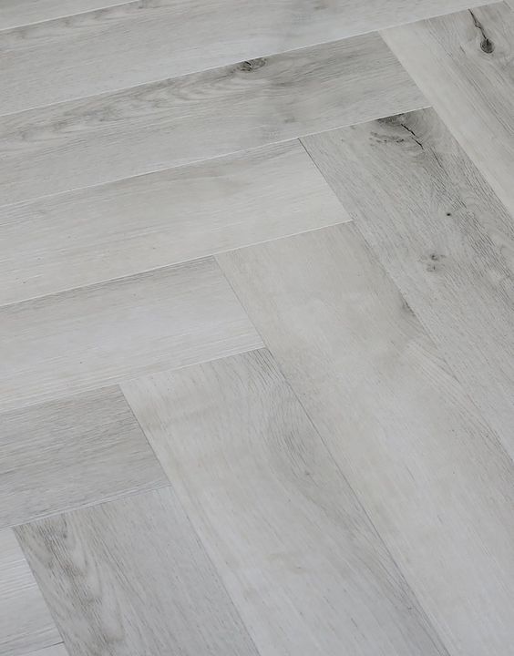 Gray and white washes herringbone wood flooring