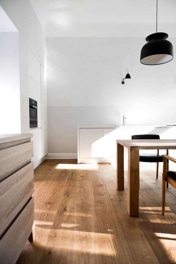 Lay the wood flooring along the length of the room
