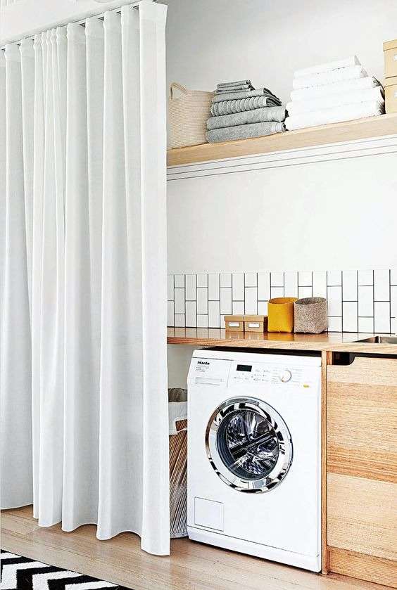 A laundry area hidden behind a white curtain