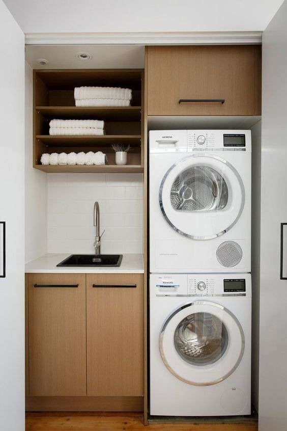 stacking the washing machine and tumble dryer on top of each other in Laundry Room