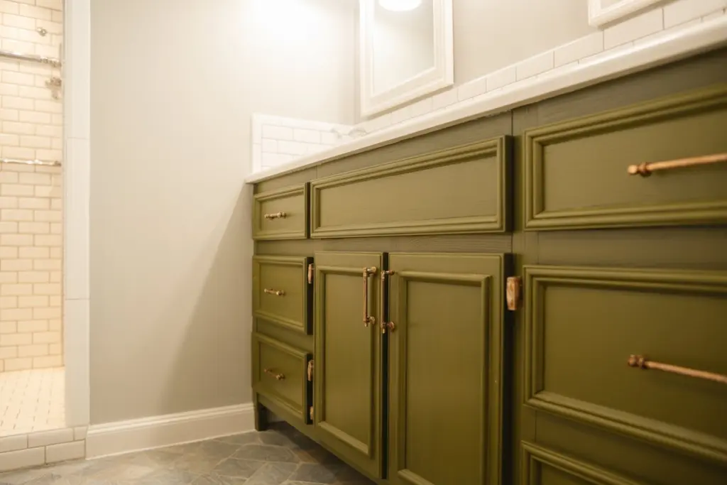 using earthy green for painting the bathroom cabinets