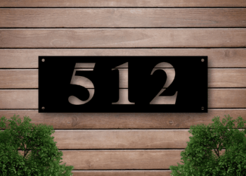 Black house number on wooden wall